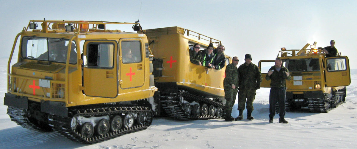 CBO employees with two yellow BV206 all-terrain vehicles with track wheels on snow in the Arctic.