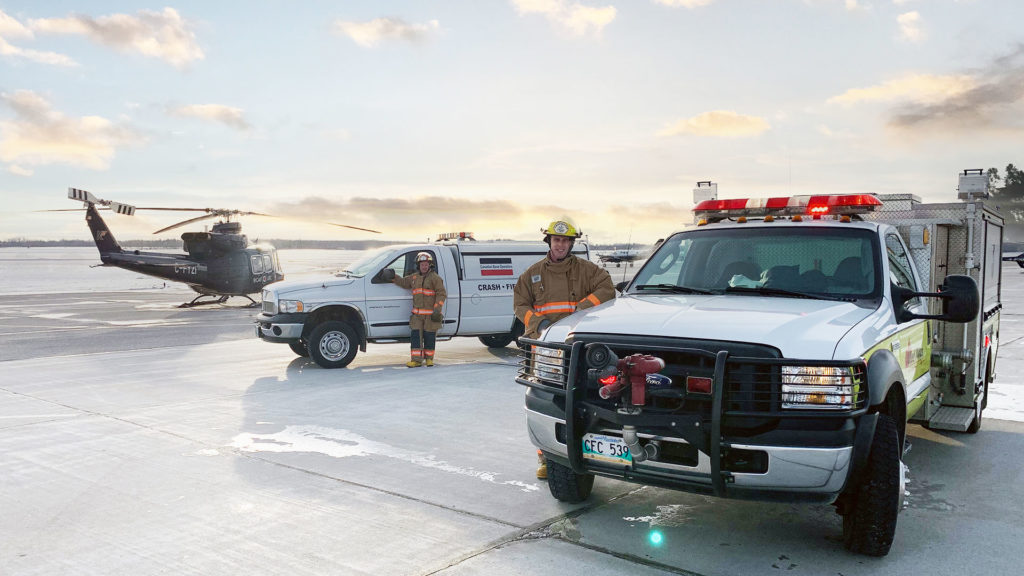 CBO Aircraft Fire and Rescue personnel standing on an airport tarmac