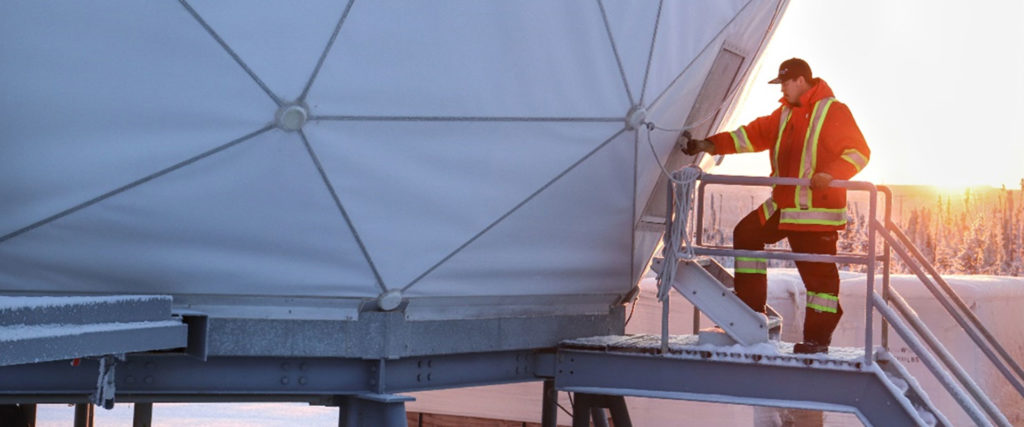 Employee entering a radome at a North Warning System site