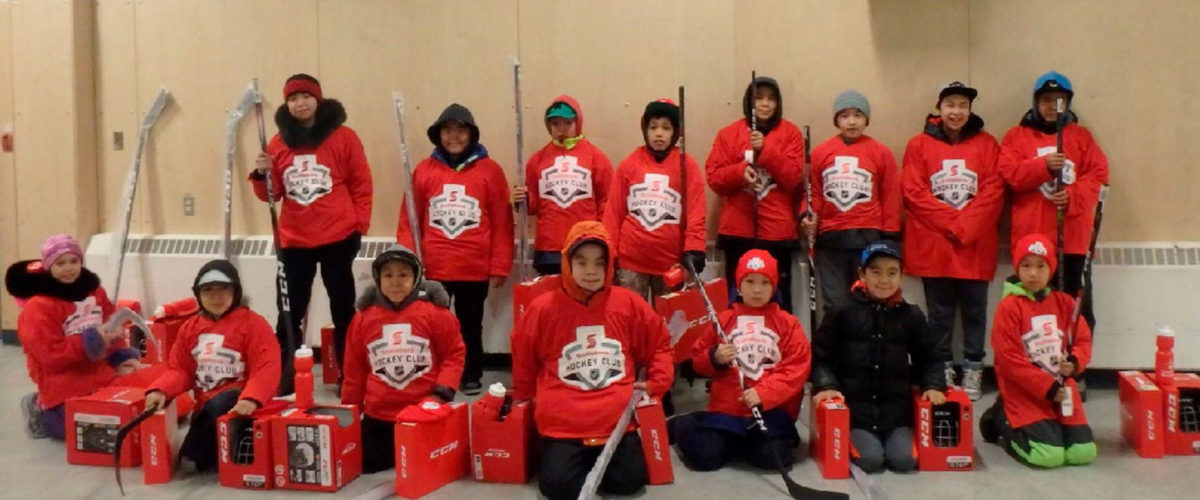 Youth from Hall Beach in Nunavut wearing new hockey equipment.