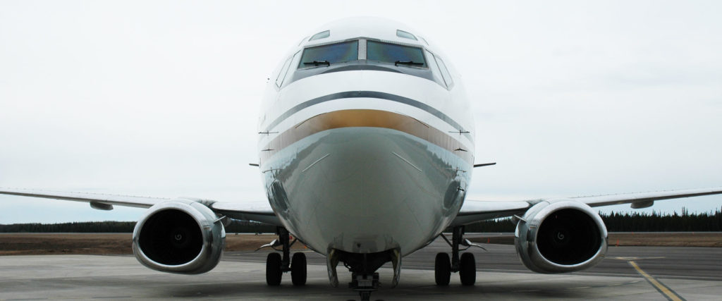 A frontal view of an airplane on an airfield tarmac.
