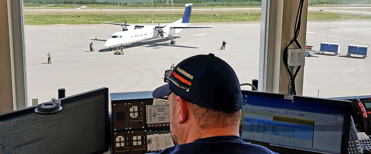 An air traffic control tower CBO employee looking out at the Suncor Firebag Aerodrome in Alberta.